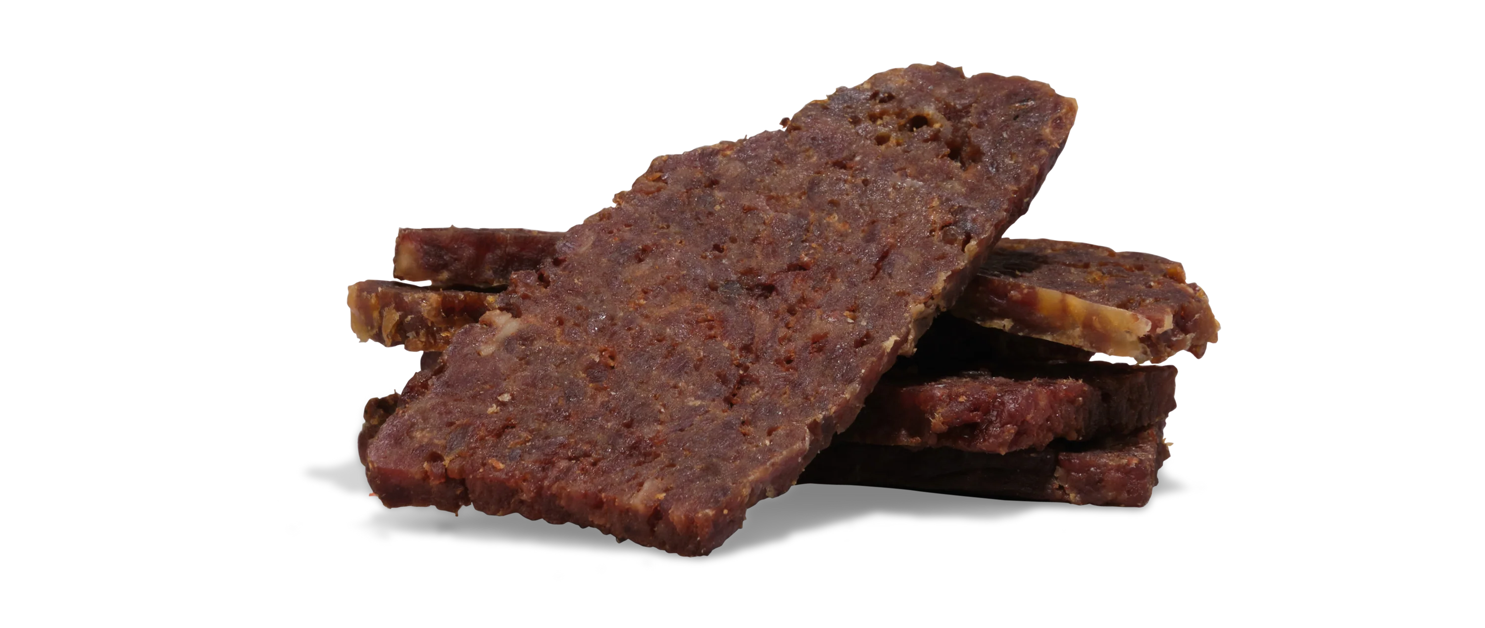 Rectangular slices of Saint Rocco's Treats Beef Treats Sampler Bundle are stacked on a white surface, revealing a rough, chewy texture with visible seasoning—great for artisan dog treat lovers.