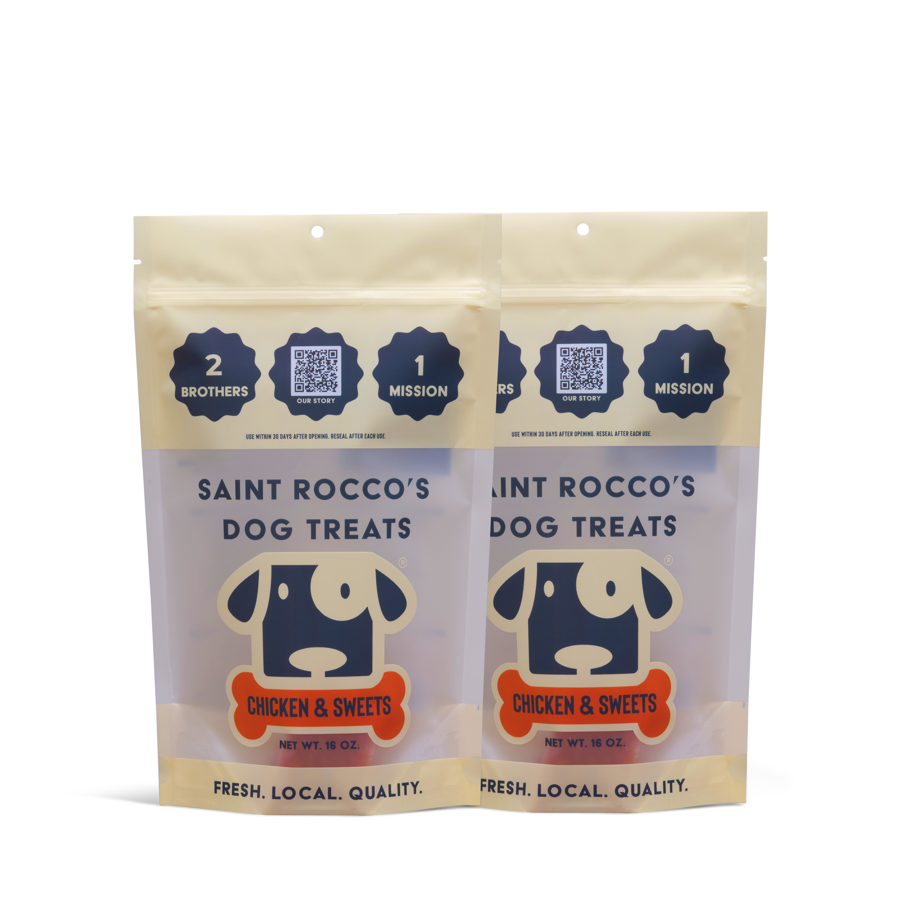 Two beige and clear 16 oz bags of Saint Rocco’s Treats, labeled Chicken and Sweets with a dog illustration and “Fresh. Local. Quality.” Each bag contains hand-crafted artisan dog treats.