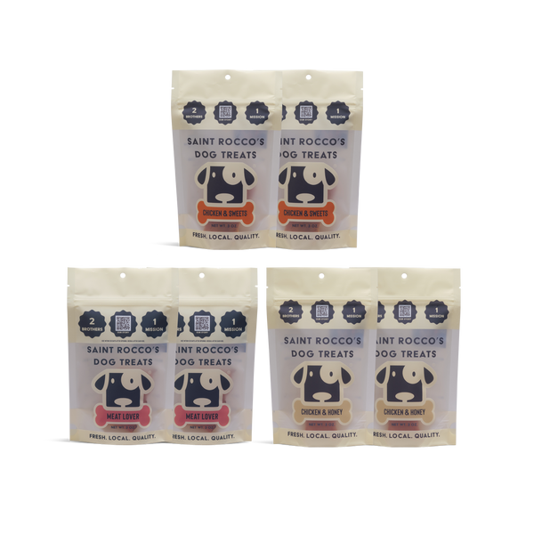 Four packages of Saint Rocco's Dog Treats, meat lover, chicken & sweets, and chicken and honey on a white background