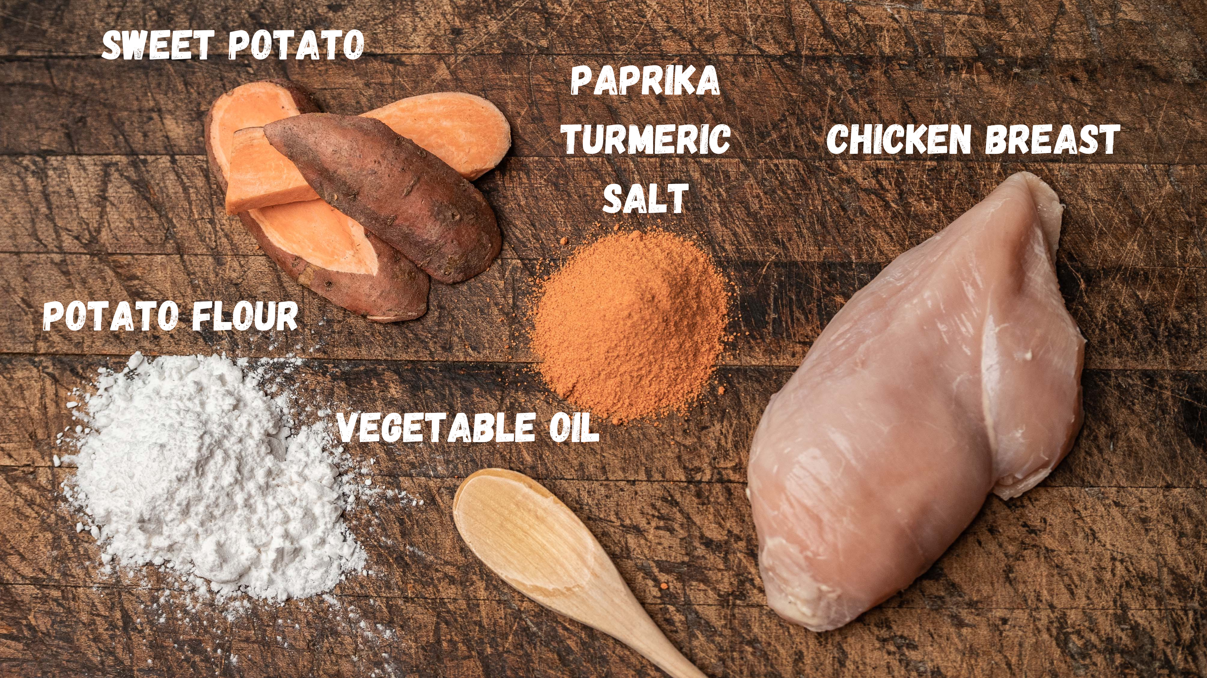 Saint Rocco's Treats Chicken and Sweets Treats features raw chicken breast, sweet potato, potato flour, vegetable oil, and spices beautifully displayed with labeled ingredients—a perfect artisan dog treat setup, complete with a wooden spoon.