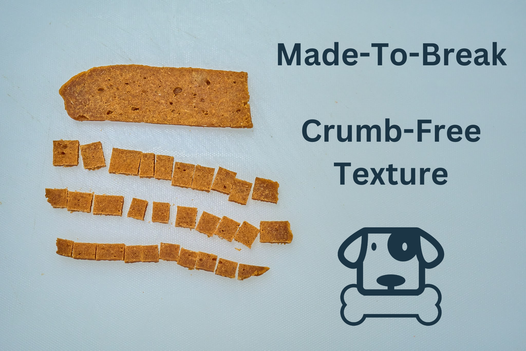 Saint Rocco's Treats Alaskan Salmon Treats, artisan dog treats cut into small squares, sit on a white surface. Beside them, text reads “Made-To-Break Crumb-Free Texture” with a dog holding a bone icon below.
