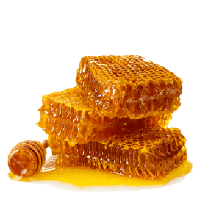 Three pieces of honeycomb stacked and covered in golden honey, with a wooden honey dipper resting beside them on a white background.