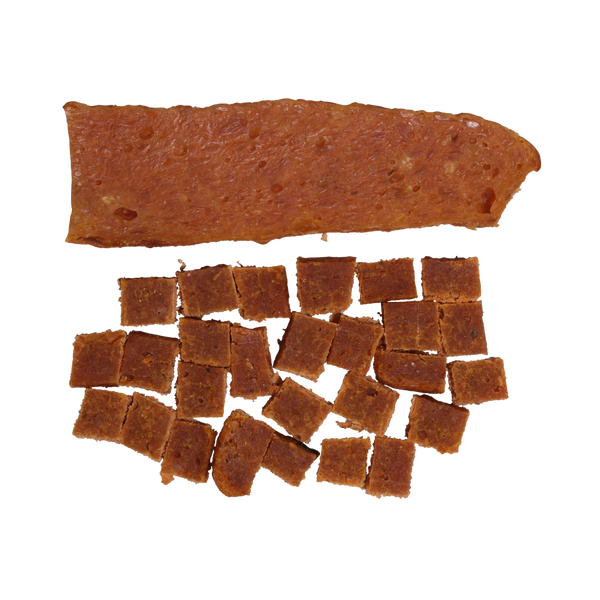 A rectangular sheet of Sample Treat by Saint Rocco's Treats sits above several small, evenly cut square pieces of the same treat, all with a reddish-brown color and displayed on a white background.