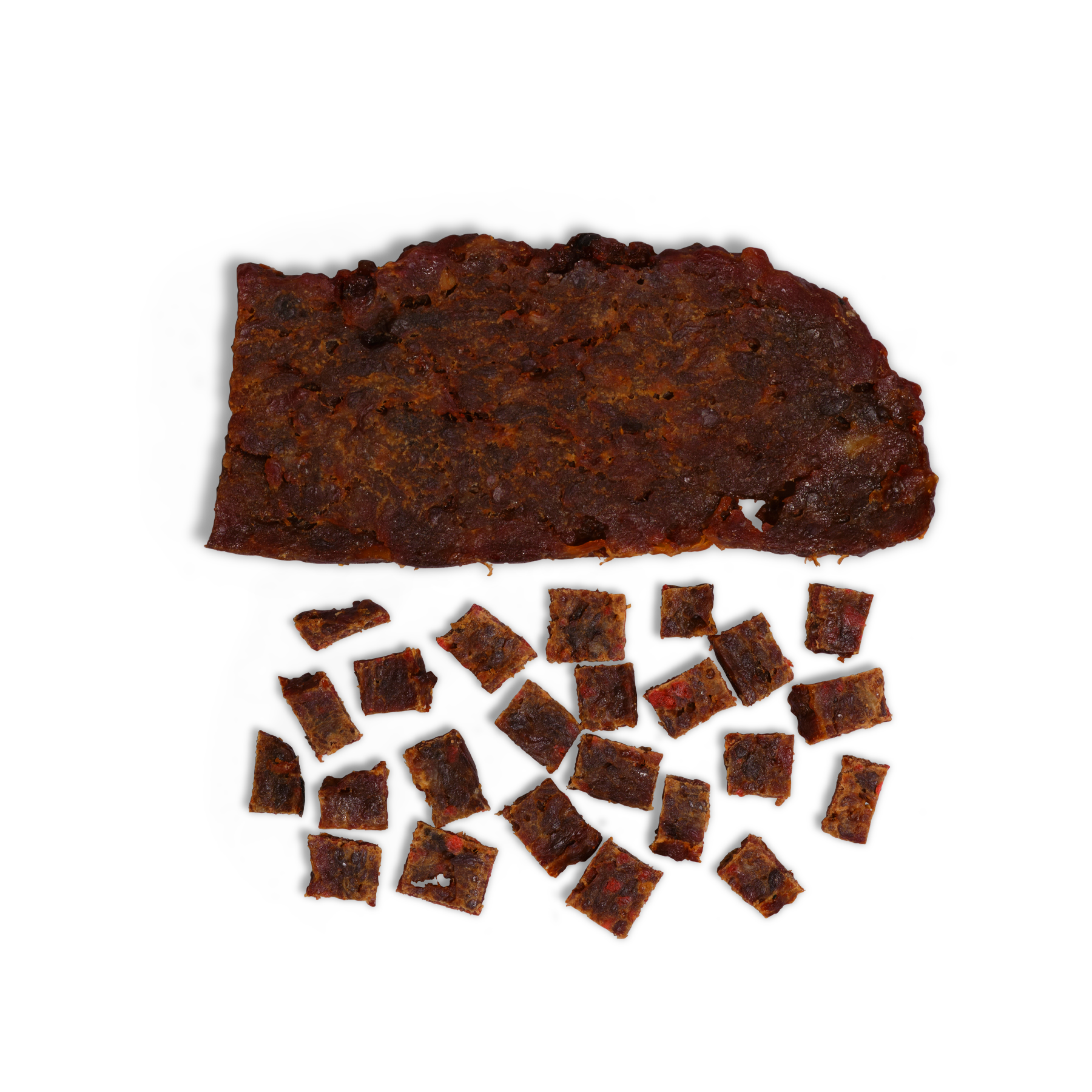 A large piece of Saint Rocco's Treats Beef and Pumpkin jerky rests above several small, square-cut handcrafted dog treats on a white background.