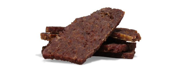 Stack of saint roccos beef pumpkin treats on a white background