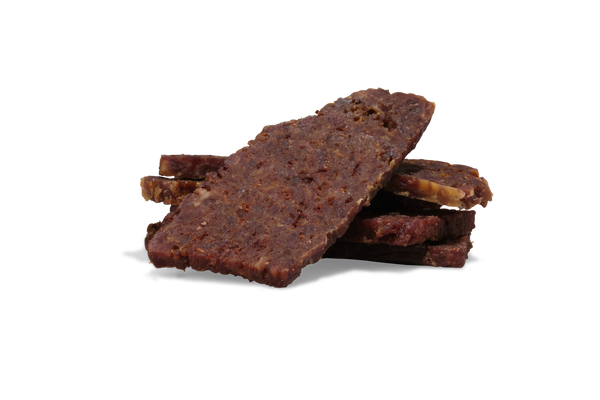 Stack of saint roccos beef and pumpkin treats on a white background