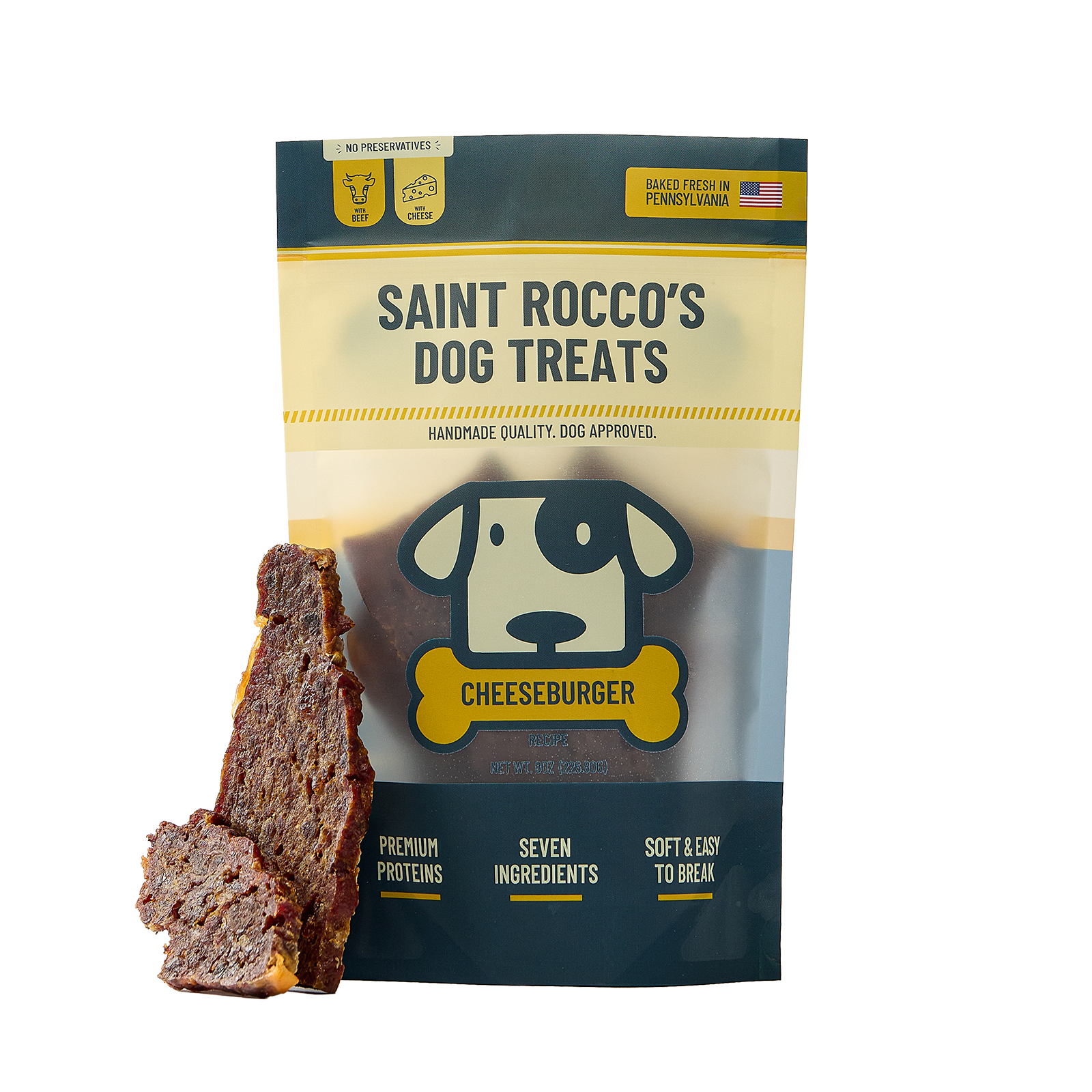 A bag of Saint Rocco's Dog Treats Cheeseburger flavor shown on a white background, with two slices of the dark brown meat treat leaning against the bag.