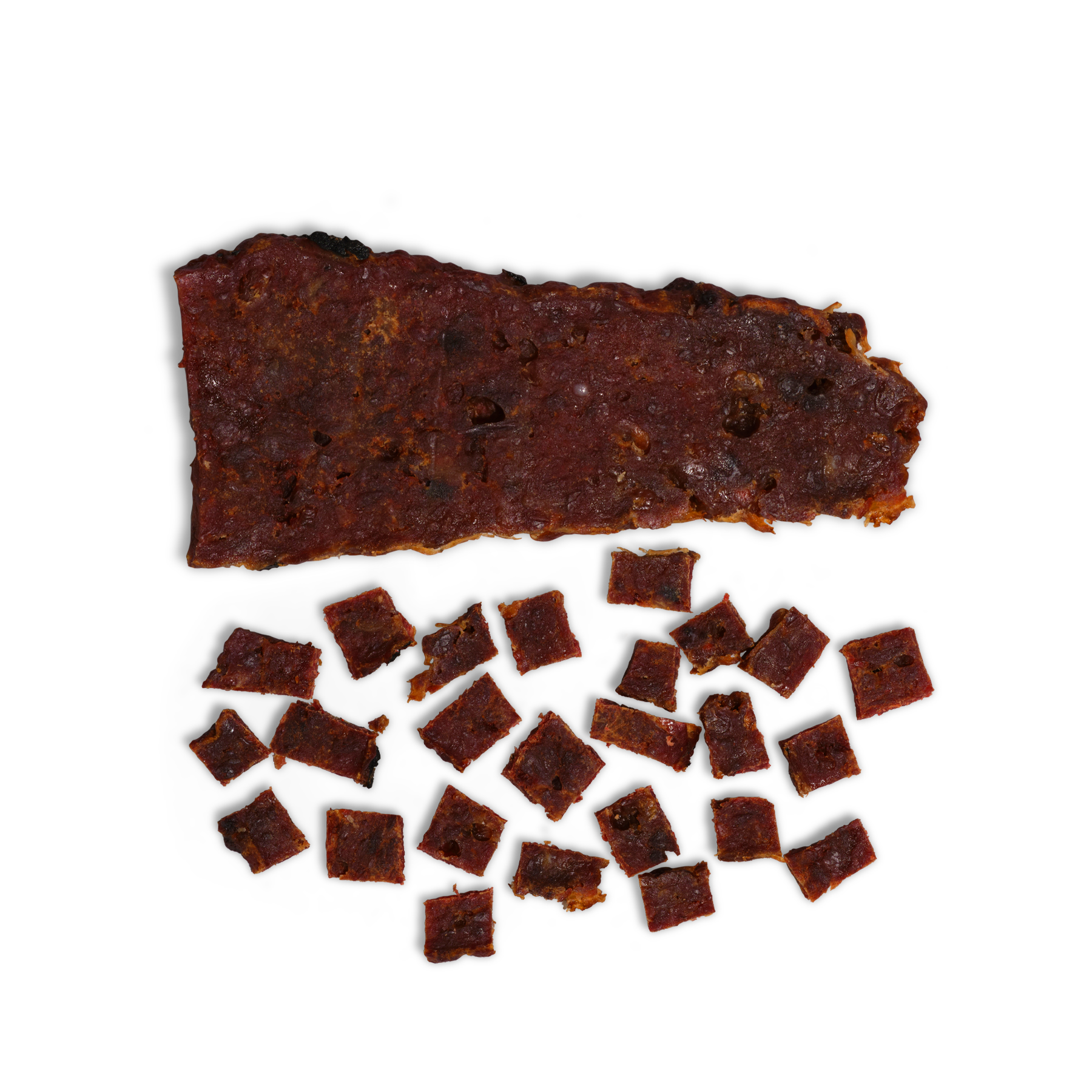A large, uneven slice of dried meat is displayed above several small, square pieces of Saint Rocco's Treats Cheeseburger Treats on a white background.