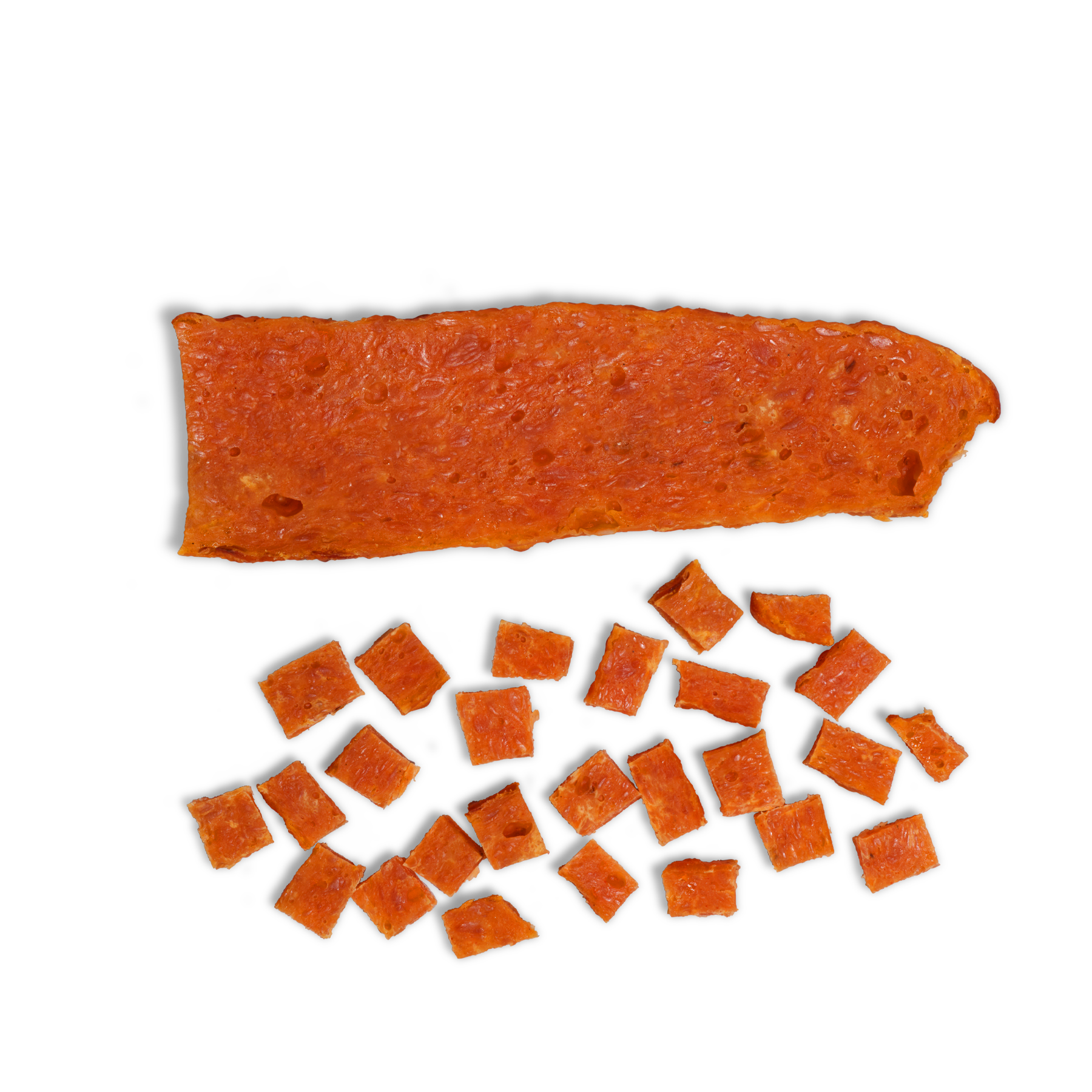 A rectangular sheet of chicken and sweet treats from Saint Rocco's Treats is shown above several small, uniformly cut cubes on a white background—perfect as hand-crafted dog treats for your pup.