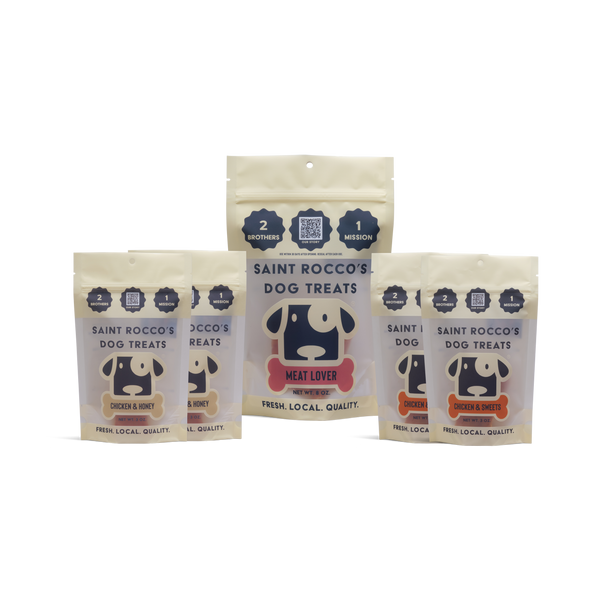 Four packages of Saint Rocco's Dog Treats on a white background