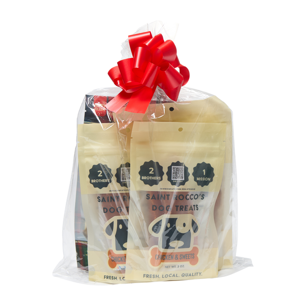 Saint Rocco's Treats Stocking Stuffer by Saint Rocco's Treats—gift-wrapped dog treat bags with a cartoon dog on the packaging and a red and white bow, perfect for holiday gifting, shown against a plain white background.