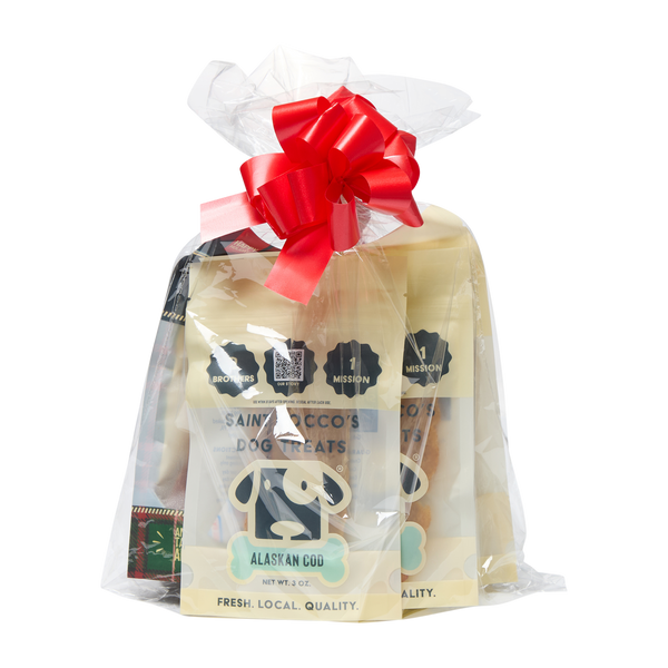 Saint Rocco's Treats Stocking Stuffer by Saint Rocco's Treats is a clear gift bag of gourmet dog treats with an Alaskan Cod label, finished with a red ribbon—perfect as a festive stocking stuffer for your pup.