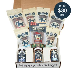 An open Saint Rocco's Naughty or Nice Box by Saint Rocco's Treats is filled with gourmet dog treats, featuring a "Happy Holidays" label and a circular tag in the corner that says "Up to $30 off.