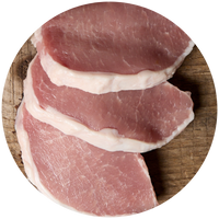 Raw pork slices on a wooden cutting board