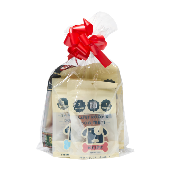 Saint Rocco's Treats Stocking Stuffer is a gift-wrapped set from Saint Rocco's Treats, featuring gourmet dog treats in beige packaging with a cartoon dog face, sealed in clear plastic with a red bow—ideal for your furry friend's holiday surprise!.