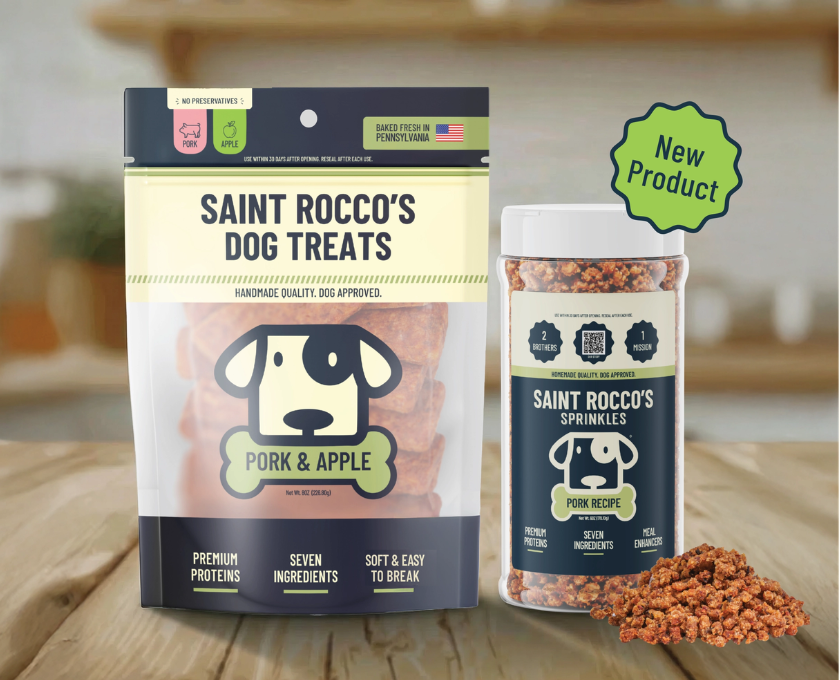Saint Rocco's dog treats packaging with a focus on pork and apple flavor and sprinkles on a wooden surface.
