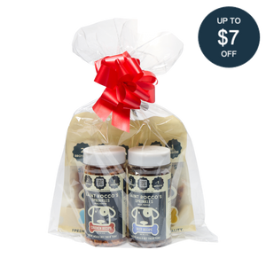 Saint Rocco's Sprinkles Stocking Stuffer by Saint Rocco's Treats: a clear-wrapped gift set with two gourmet dog sprinkle jars and two yellow bags. Great as a holiday dog stocking stuffer! Includes circular label: Up to $7 off.