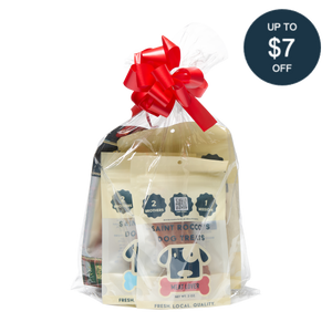 Saint Rocco's Treats Stocking Stuffer: hand-crafted dog treats in cream packaging, wrapped in clear plastic with a red bow. A dark blue sticker says “UP TO $7 OFF.” Perfect gourmet stocking stuffer for your pup from Saint Rocco’s Treats!.