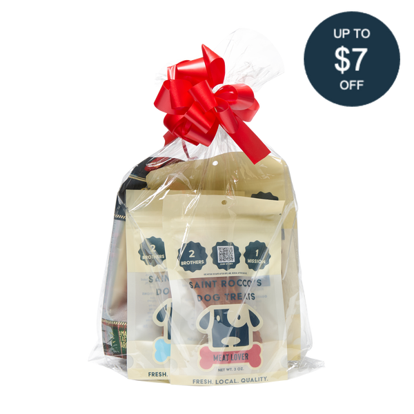 Saint Rocco's Treats Stocking Stuffer: hand-crafted dog treats in cream packaging, wrapped in clear plastic with a red bow. A dark blue sticker says “UP TO $7 OFF.” Perfect gourmet stocking stuffer for your pup from Saint Rocco’s Treats!.