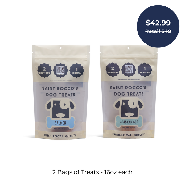The Saint Rocco’s Treats Seafood Sampler Bundle includes two 16oz bags of artisan dog treats—Salmon and Alaskan Cod flavors. A blue circular label displays $42.99 (Retail $49). Below it reads: 2 Bags of Treats - 16oz each.