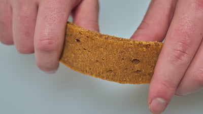 salmon treat being broken into smaller pieces